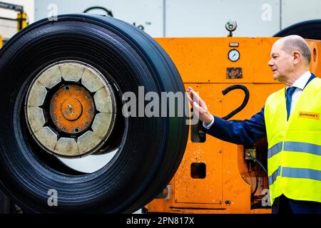 Hanover, Germany. 17th Apr, 2023. During his visit, German Chancellor Olaf Scholz (SPD) obtains information from the Continental plant on the subject of retreading truck and bus tires. Credit: Moritz Frankenberg/dpa/Alamy Live News Stock Photo