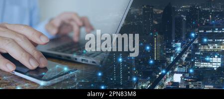 Digital Technology. Futuristic Tech Background: Man Using Mobile Phone and Laptop for Big Data Analysis and Internet Network Connection in a Smart Cit Stock Photo
