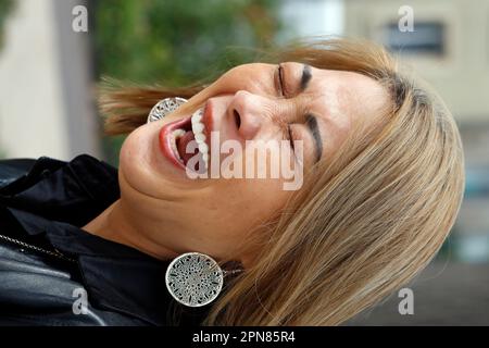 Portrait of young woman laughing. Stock Photo