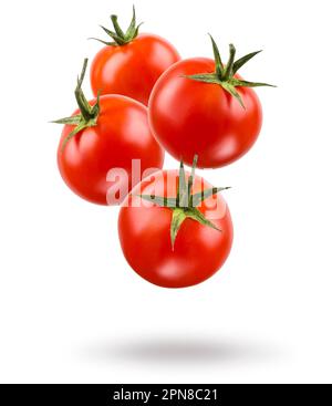 Small red cherry tomatoes floating on white background. Stock Photo