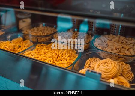 Traditional Italian pasta products displayed at the window of a local pasta shop in Pisa, Italy. High quality photo Stock Photo