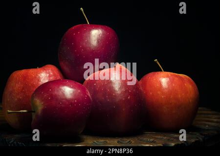 Very sweet and ecological red apples on a black background collected on the Iberian Peninsula. Stock Photo