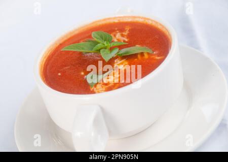 Tomato Soup with cheese and basil Stock Photo