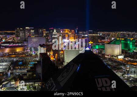 A picture of the Las Vegas Strip at night, with the top of the pyramid of the Luxor Hotel and Casino on the bottom. Stock Photo