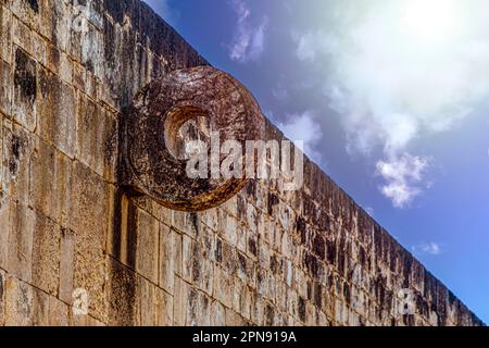 Ball game wall and basket from the Mayan ruins of Chichen Itza in the Yucatan peninsula under the Caribbean sun, these are the old ruins of the Mayan Stock Photo