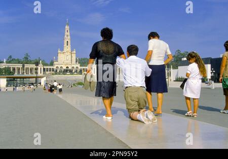 Fatima, Portugal - May 12, 2019: Shrine of Fatima. Pilgrim fulfills their penance and or promise on the knees along the prayer area to the Chapel of t Stock Photo