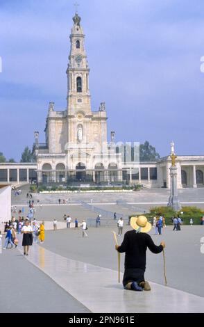 Fatima, Portugal - May 12, 2019: Shrine of Fatima. Pilgrim fulfills their penance and or promise on the knees along the prayer area to the Chapel of t Stock Photo