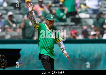 Former Oakland Athletics Bert Campaneris, left, and John 'Blue Moon' Odom  throw the ceremonial first pitches prior to the baseball game against the  Kansas City Royals Saturday, June 27, 2015, in Oakland