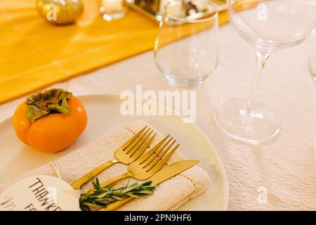Thanksgiving dinner table setting. Golden cutlery close-up Stock Photo