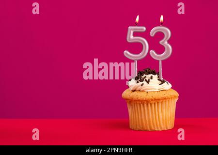 Birthday cake with candle number 53 - Rhodamine Red foamy background Stock Photo