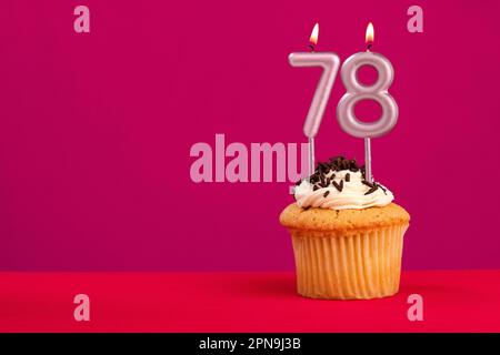 Candle number 78 - Cake birthday in rhodamine red background Stock Photo