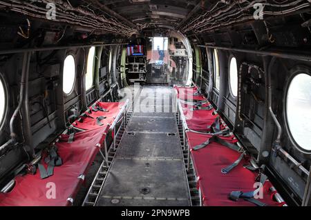 A CH-46 Sea Knight helicopter hovers over the flight deck of the ...