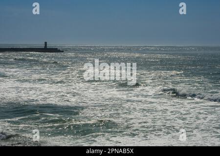 Oporto, Portugal. February 15, 2023. Atlantic Ocean and a lighthouse in Oporto Stock Photo