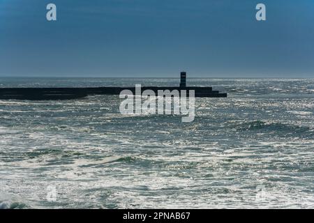 Oporto, Portugal. February 15, 2023. Atlantic Ocean and a lighthouse in Oporto Stock Photo