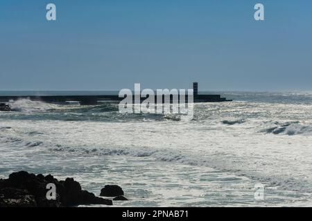 Oporto, Portugal. February 15, 2023. Atlantic Ocean and a lighthouse in Oporto Stock Photo