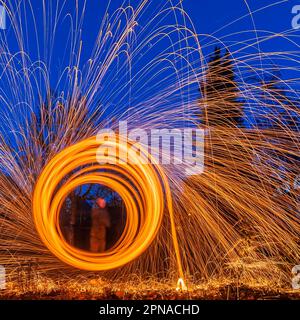 Lightpainting, sparks flying in circles through the air, Stuttgart, Baden-Wuerttemberg, Germany Stock Photo