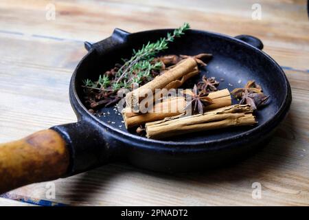 Cinnamon sticks and star anise in a pan Stock Photo