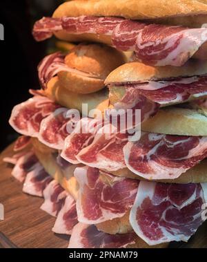 Freshly made Iberico Spanish ham baguette sandwiches in a delicatessen Stock Photo