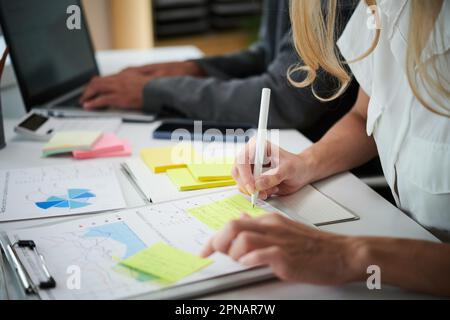 Financial analysts working with reports, preparing for meeting Stock Photo