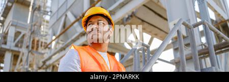 Skillful multiethnic engineer working on construction site Stock Photo