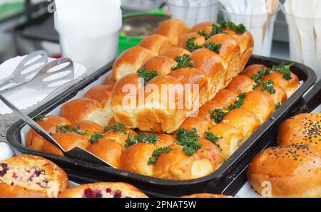 Stand with fresh sweet and savoury pastries on display at the Náplavka Farmers Market in winter at the beginning of the new season Stock Photo