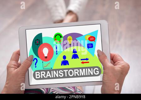 Brainstorming concept shown on a tablet held by a woman Stock Photo