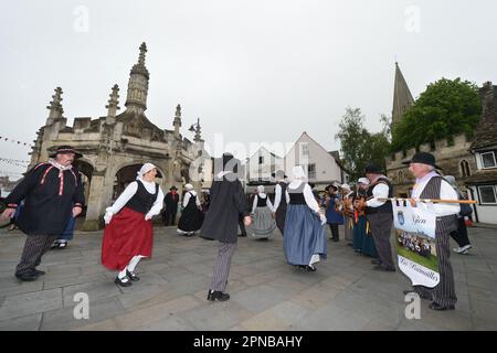 The Folk Abeille dance group from Gien, France perform at the Market Cross of their twin town Malmesbury in Wiltshire as part of the town's Jubilee ce Stock Photo