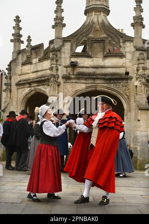 The Folk Abeille dance group from Gien, France perform at the Market Cross of their twin town Malmesbury in Wiltshire as part of the town's Jubilee ce Stock Photo