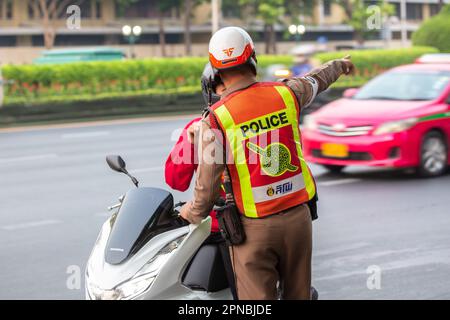 Bangkok, Thailand - April 15, 2023: Police officer on the streets of Bangkok, Thailand. Stock Photo