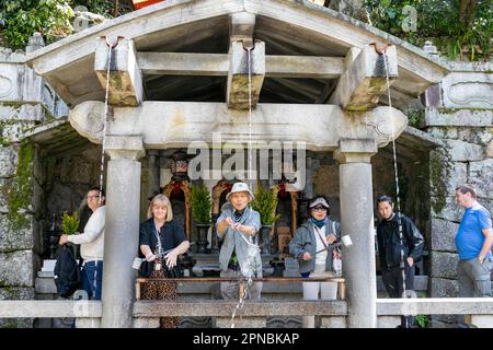 April 2023, Kiyomizu-dera temple in Kyoto,   people drinking from the Otowa waterfall for luck,Japan,Asia Stock Photo