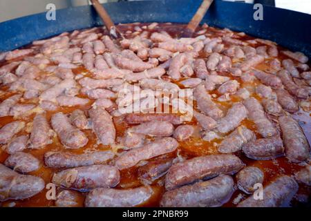 The agriculture fair (Comice Agricole) of Saint-Gervais Mont-Blanc. Cooking diots. A diot is a sausage from the French region of Savoy. Saint-Gervais. Stock Photo