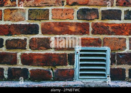 Small metal ventilation grille on the brick wall in Halmstad, Sweden Stock Photo