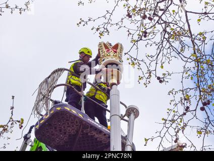 London, England, UK. 18th Apr, 2023. Workers install decorative crowns and Union Jacks in The Mall as preparations for the coronation of King Charles III and Queen Camilla, which takes place on May 6th, continue around London. (Credit Image: © Vuk Valcic/ZUMA Press Wire) EDITORIAL USAGE ONLY! Not for Commercial USAGE! Credit: ZUMA Press, Inc./Alamy Live News Stock Photo