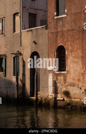 View on buildings with red walls over channel in old city in sunny day Stock Photo