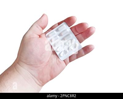 Hand holding pills isolated on black Stock Photo
