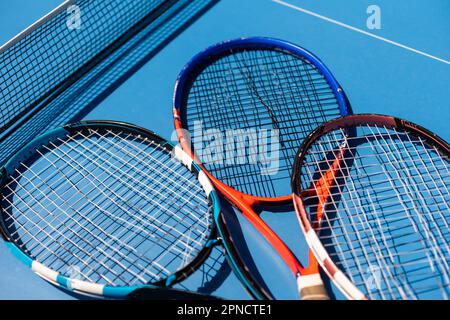 broken tennis rackets on clay tennis court Stock Photo