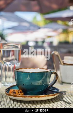 Close-up of espresso coffee in a single shot glass cup with saucer