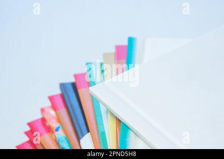 multi-colored spines of photo books close-up, partial blur Stock Photo