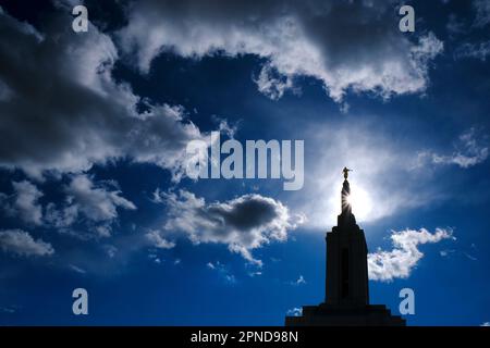 Angel Moroni on top of Mormon LDS Church of Jesus Christ Temple with sky and clouds Stock Photo