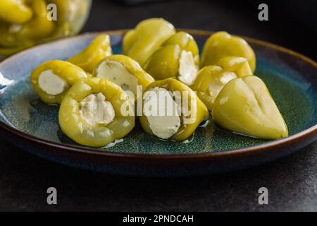 Peppers stuffed with cream cheese on the plate. Stock Photo