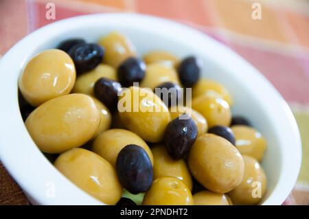Black and green olives in olive oil Stock Photo