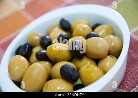 Black and green olives in olive oil Stock Photo