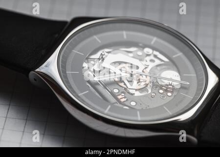 Biel, Switzerland - October 28, 2021: Macro photo of Swiss made quartz Black Skeleton wrist watch by Swatch Stock Photo