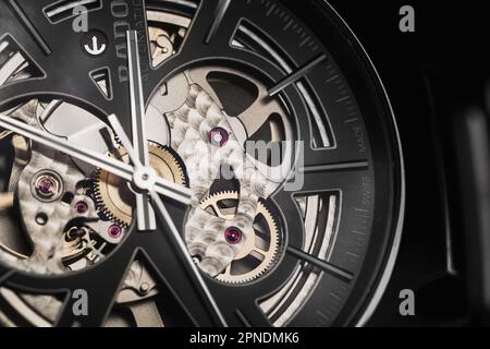 Lengnau, Switzerland - November 11, 2021: Macro photo of luxury Swiss made mechanical skeleton wrist watch with black clock face. Rado True Open Heart Stock Photo