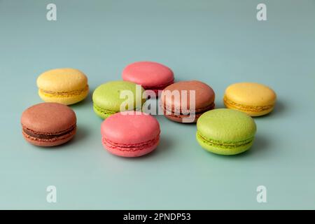 Multi color macaroons on turquoise background close up Stock Photo
