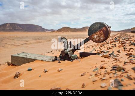 Old rusty unused railroad switch at Wadi Rum train station, sandy desert around Stock Photo