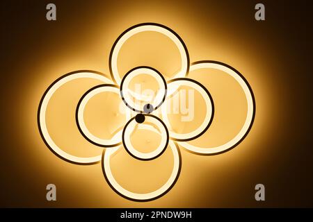 Luminous modern LED ring lamp on the ceiling. Bottom view. Stock Photo
