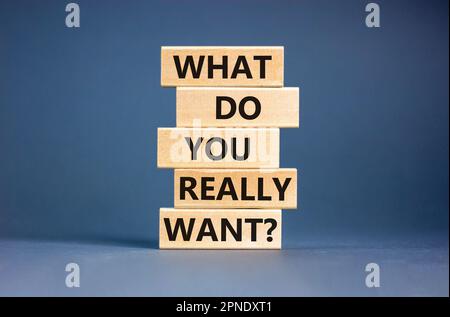 What do you really want symbol. Concept words What do you really want on wooden block. Beautiful grey table grey background. Business and what do you Stock Photo