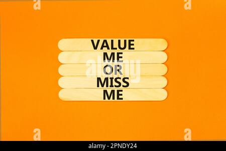 Value or miss me symbol. Concept words Value me or miss me on wooden stick. Beautiful orange table orange background. Business psychological and value Stock Photo