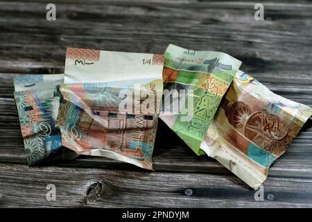 Kwd Cash crumpled Kuwaiti money of quarter, half and one KWD Kuwait dinar bills ...